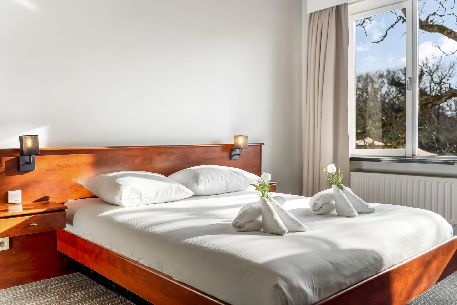 Bedroom with decked beds and beautifully decorated towels
